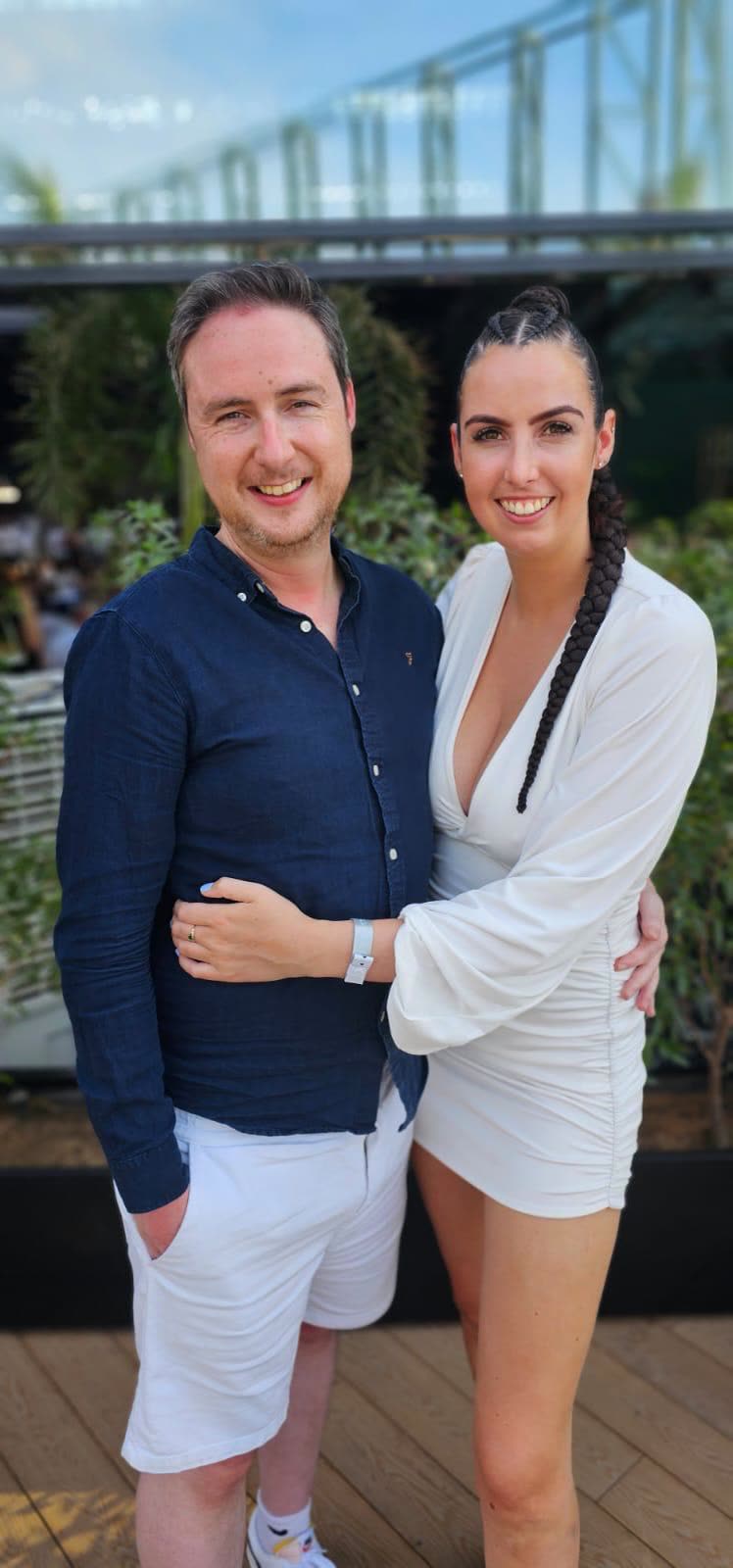 The couple dressed up, arm in arm